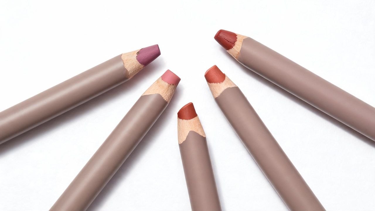 Korean chunky lip liner products flat lay with thick jumbo pencils in neutral mauve, muted rose and terracotta shades