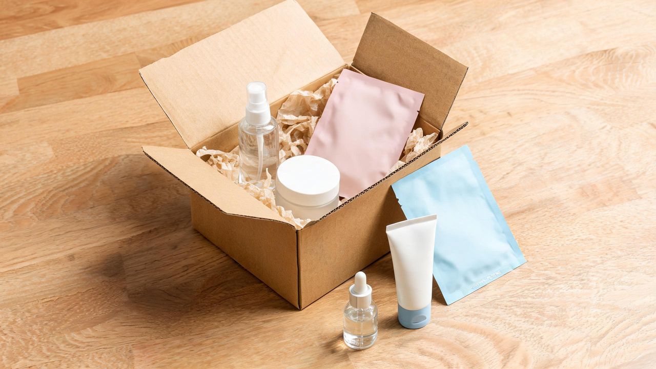 Korean skincare products in an open cardboard shipping box, an authentic K-beauty online order unboxing